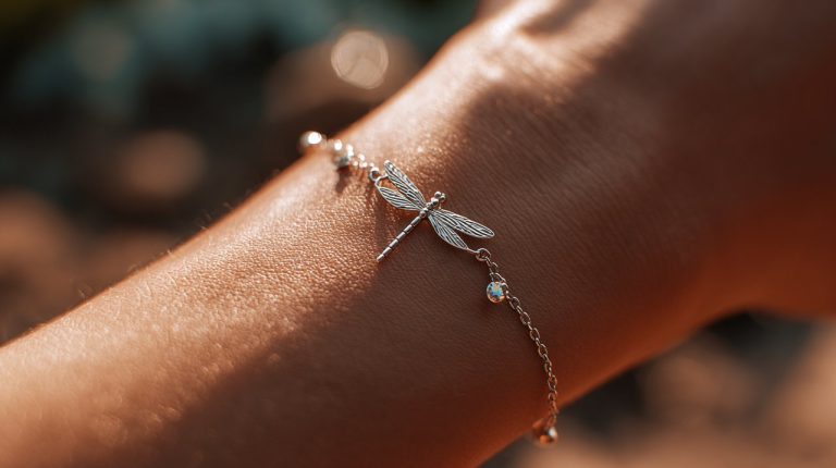 A delicate dragonfly bracelet on a wrist.