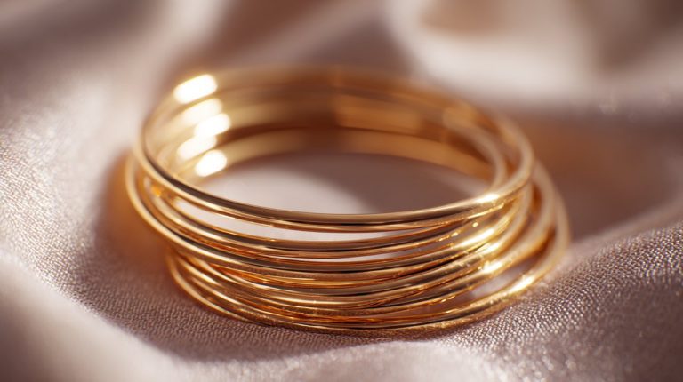 A set of seven gold semanario bracelets stacked together.