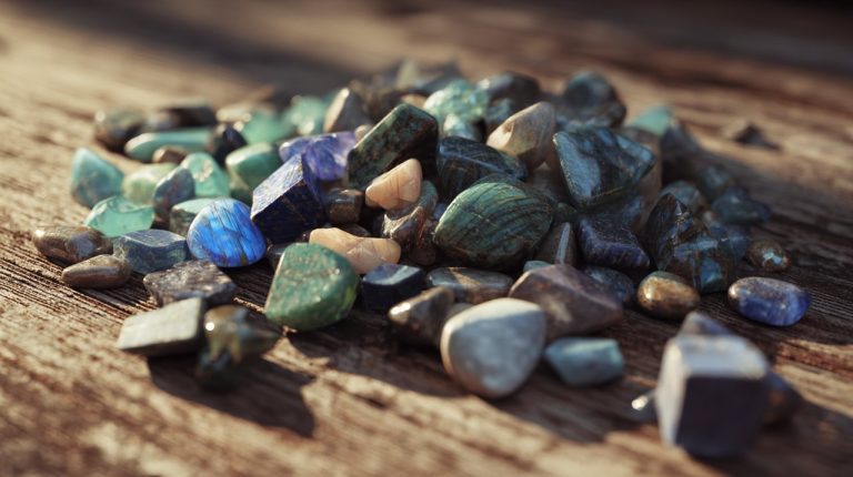 A collection of natural transformation stones scattered on wood.