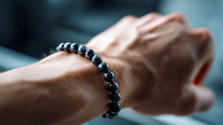 A black tourmaline stone bracelet on a person's wrist
