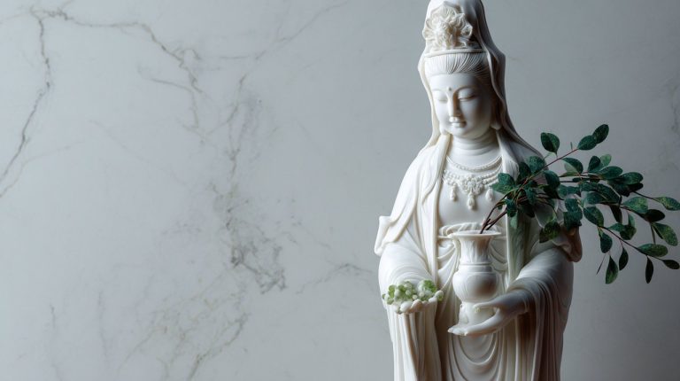 A serene white marble Kuan Yin statue.