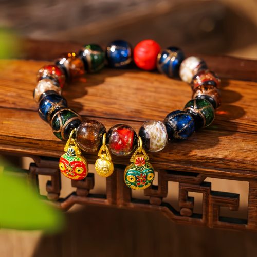 Buntes Zinnober-Armband mit Goldschluckender Bestie Buntes Zinnober-Armband mit Goldschluckender Bestie