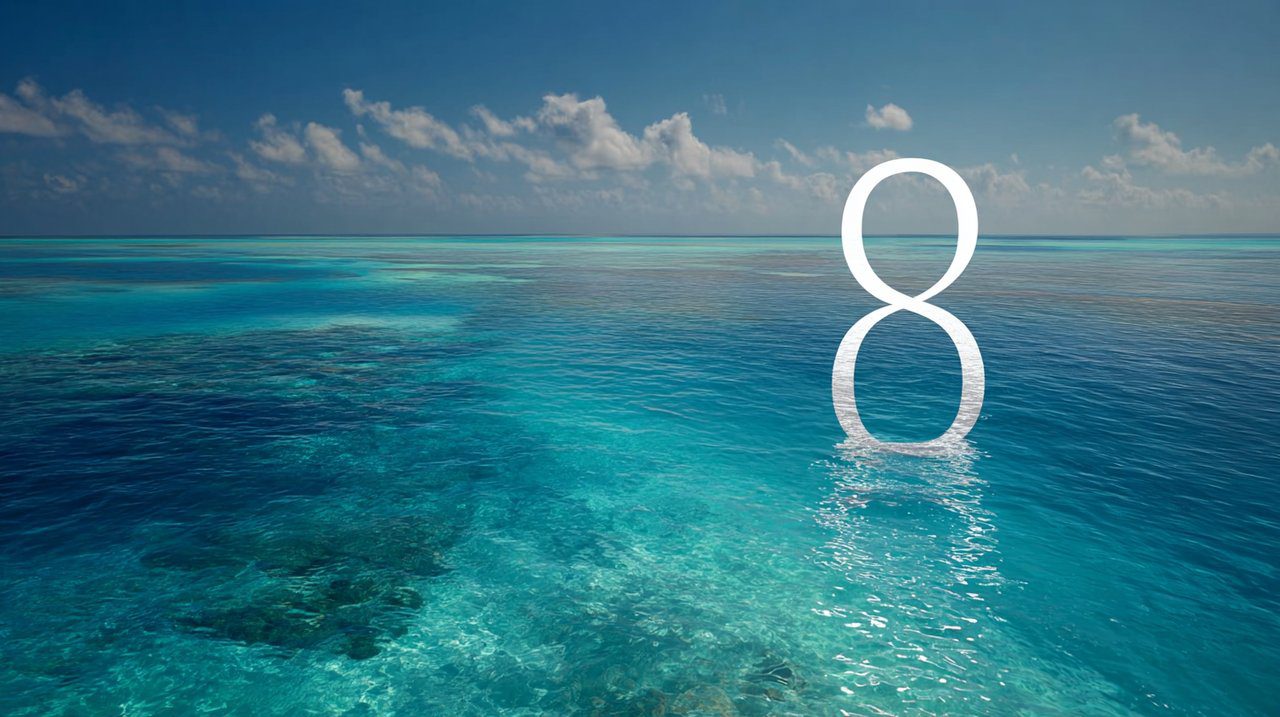 The number 8 gently shimmering, formed by crystal-clear water currents on the surface of a vast, calm turquoise ocean.